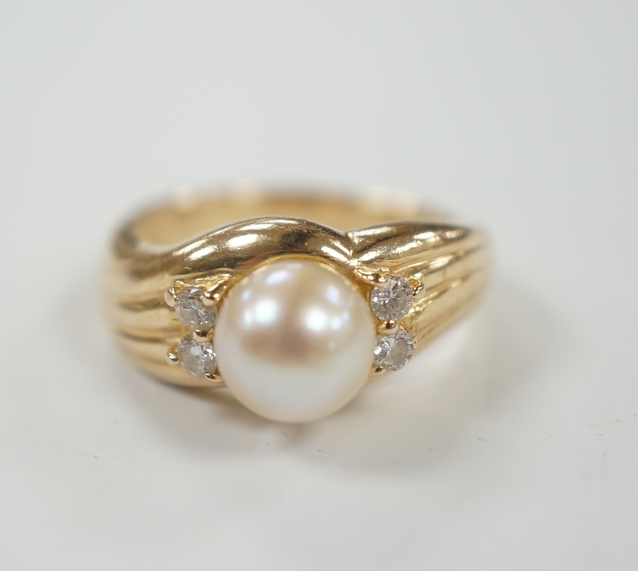 A modern 585 yellow metal, single stone cultured pearl and four stone diamond set ring, size I, gross weight 3.9 grams.